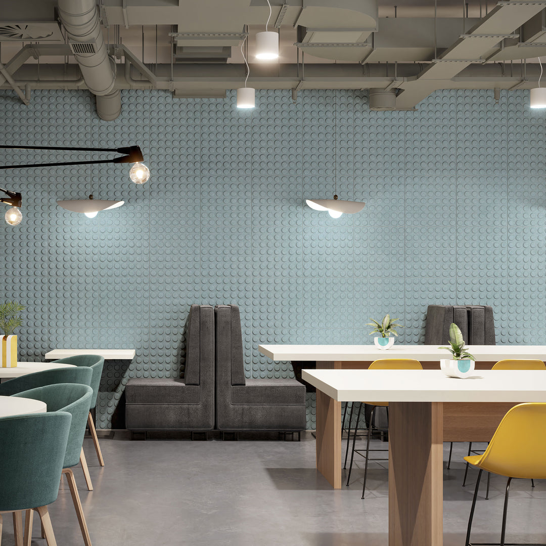 Pale blue Loop Harmony3D acoustic wall panels behind tables in a modern cafe workspace