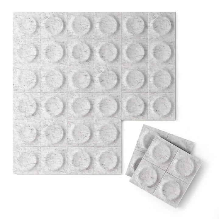 Light gray Cirque Harmony3D PET felt 3D acoustic wall panel with a raised circular pattern by Inhabit